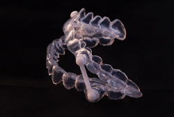 oral appliance against a black background