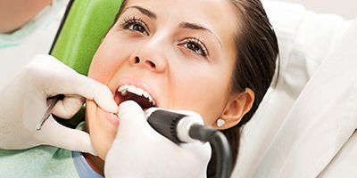 Female patient being examined by dentist