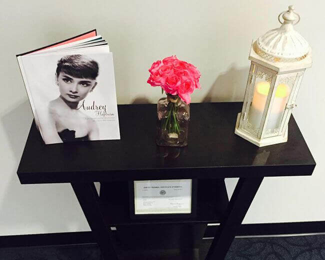 Table decorated with a book, flower and candle