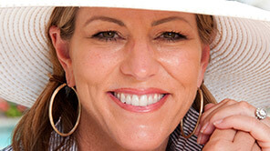 Lady wearing sun hat smiling jovially
