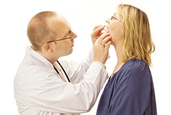 Dentist checking fit of oral appliance