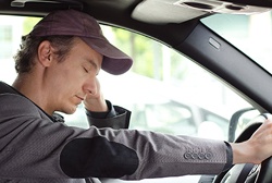 Exhausted man falling asleep while driving