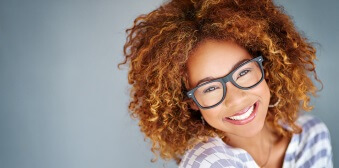 Young lady sporting glasses with stunning smile