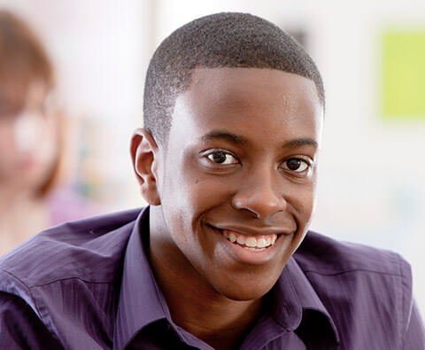 Young man in button up flashing confident smile